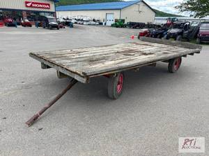 lot 128 image: Wooden flat wagon with running gear...