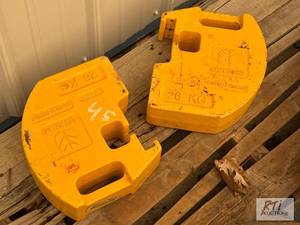 lot 45 image: (2) New Holland skid steer weights....