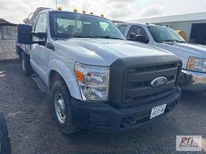 lot 1 image: 2011 Ford F350 regular cab flatbed....