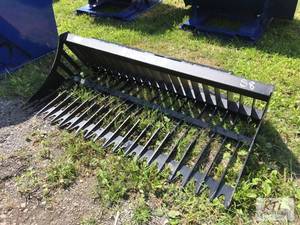lot 12 image: New 66in rock bucket for skid steer...