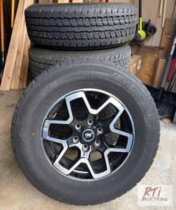 lot 238 image: Set of rims, tires, and lug nuts fr...